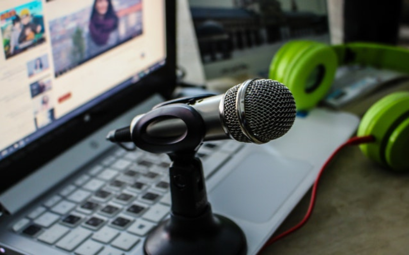 a laptop setup with microphone and headphones